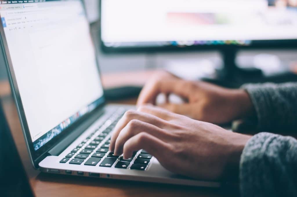 man typing on a computer