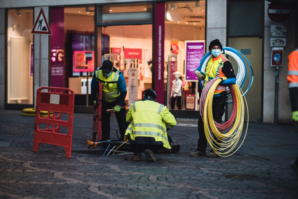 construction workers trenching fiber cables
