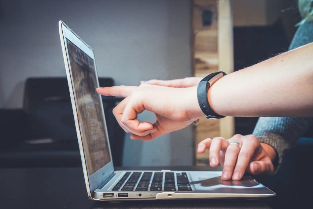 Two fingers pointing at a computer 2