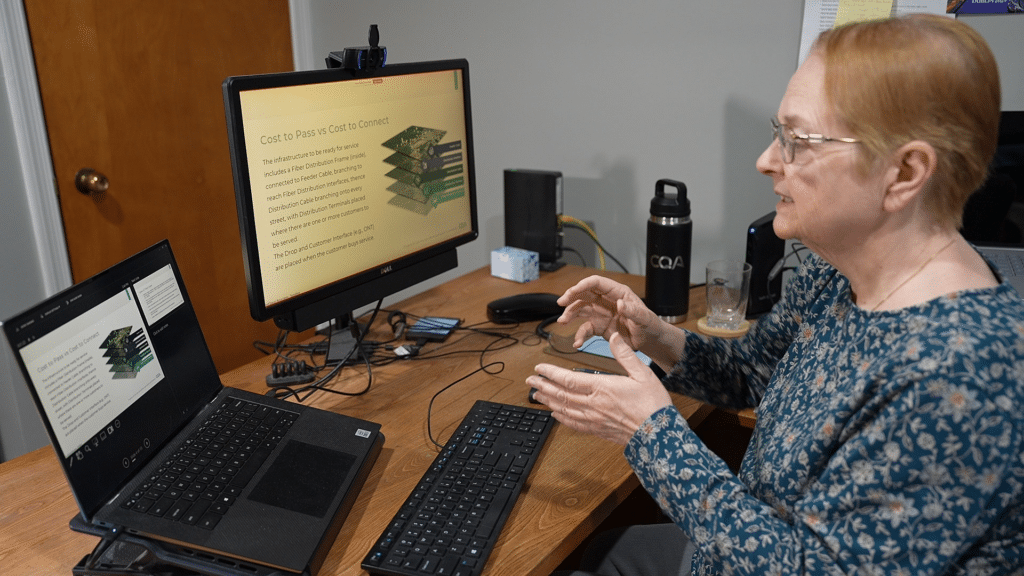 Telecom pioneer, Joann Lawler, discusses broadband infrastructure planning with a colleague. 